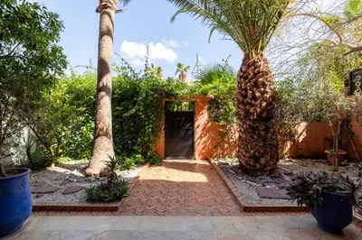 a door in a garden with two palm trees at Cosy Villa Sabah With Private Pool in Marrakech