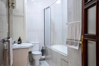 a white bathroom with a toilet and a sink at Cosy Villa Sabah With Private Pool in Marrakech