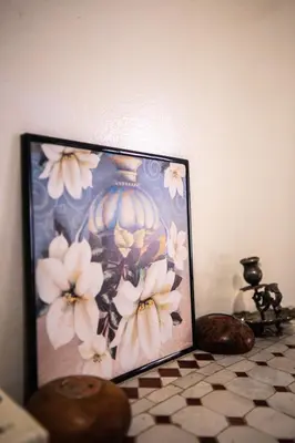 a picture of a vase with flowers on a counter at Cosy Villa Sabah With Private Pool in Marrakech