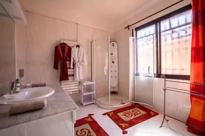 a white bathroom with a sink and a shower at Cosy Villa Sabah With Private Pool in Marrakech