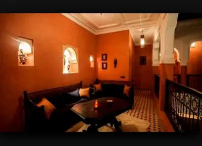 a living room with a couch and a table at Riad Mounlight in Marrakech