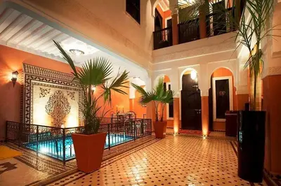 a lobby with potted plants in a building at Riad Mounlight in Marrakech