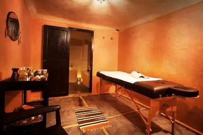 a room with a bed in the corner of a room at Riad Mounlight in Marrakech