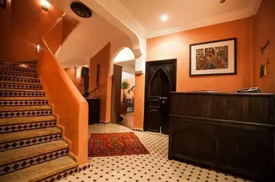 a hallway with a staircase in a house at Riad Mounlight in Marrakech
