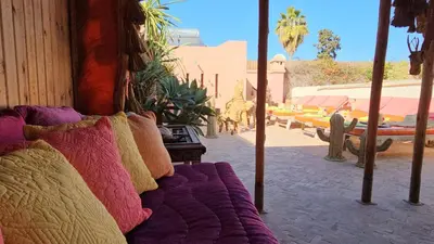 a bed sitting on the side of a building at Riad Jnane d'Ô in Marrakech