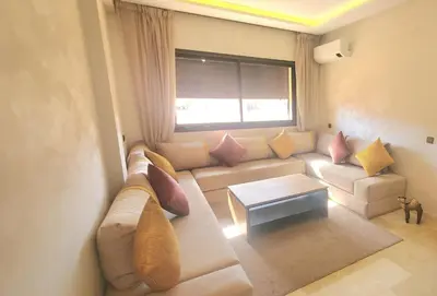 a living room with a couch and a window at appart Marrakech in Marrakech