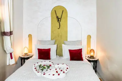 a bedroom with a bed with a clock on the wall at Riad La Famille in Marrakech
