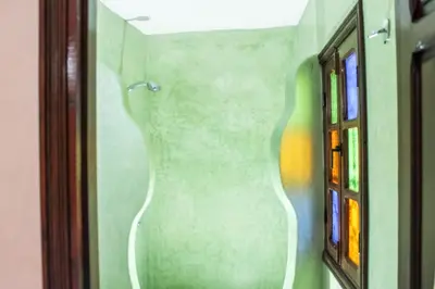 a painting of a vase on the wall in a bathroom at Riad La Famille in Marrakech