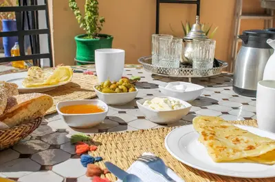 a table with plates of food on top at Riad La Famille in Marrakech