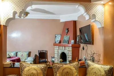 a living room with a couch and a fireplace at Riad La Famille in Marrakech