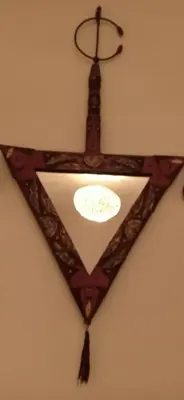 a ceiling light in the shape of a star on a wall at Riad TaTam House in Marrakech
