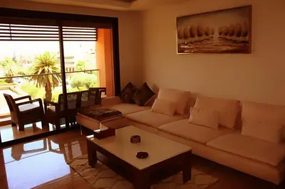 a living room with a couch and a table at Superbe appartement à l Hivernage in Marrakech