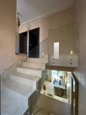 a glass staircase in a house with a living room at villa jardin de l'Atlas in Marrakech