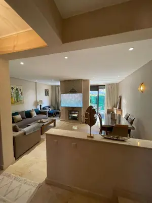 a large living room with a couch and a table at villa jardin de l'Atlas in Marrakech