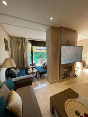 a living room with a couch and a fire place at villa jardin de l'Atlas in Marrakech