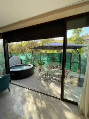 a patio with a table and an umbrella at villa jardin de l'Atlas in Marrakech