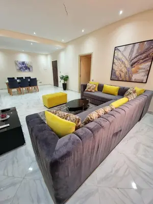 a large living room with a large couch and tables at Marrakech medina inn in Marrakech