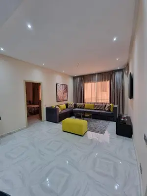a living room with a couch and a yellow chair at Marrakech medina inn in Marrakech