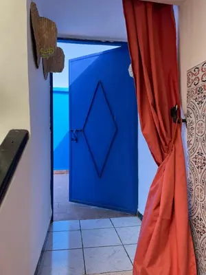 a blue door in a room with a curtain at Riad Sofia signature in Marrakech