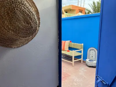a view of a patio from a door with a rattan chair at Riad Sofia signature in Marrakech