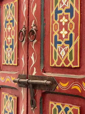 a red door with a metal handle on it at Riad Sofia signature in Marrakech