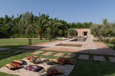 a group of pillows on the grass in a park at Pavillon Terra Ababila en Exclusivité in Marrakech