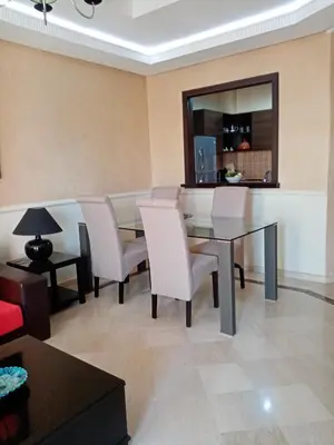 a dining room with a glass table and chairs at HERMINIE ATLAS in Marrakech