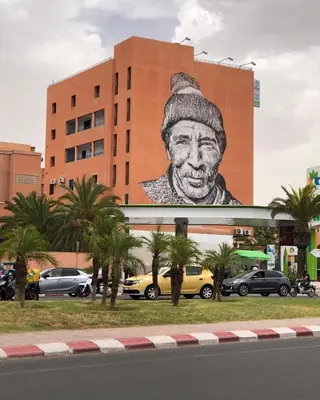 a large painting of a man on the side of a building at Deluxe Apartment in Marrakesh. hevernage flat in Marrakech
