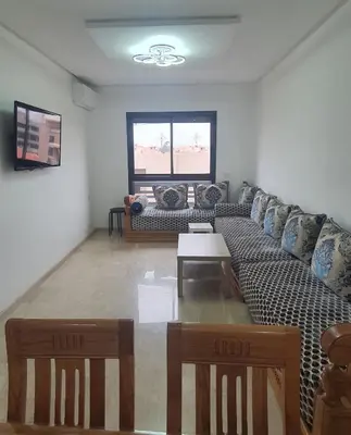 a living room with a couch and a table at Deluxe Apartment in Marrakesh. hevernage flat in Marrakech