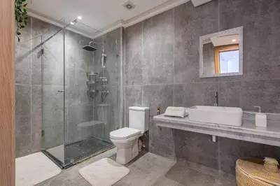a bathroom with a shower and a toilet and a sink at Haut-Standing, Marrakech Guéliz, Piscine in Marrakech