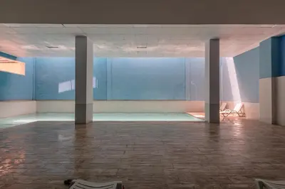 an empty room with blue walls and chairs in it at Haut-Standing, Marrakech Guéliz, Piscine in Marrakech