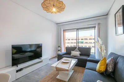 a living room with a couch and a tv at Haut-Standing, Marrakech Guéliz, Piscine in Marrakech