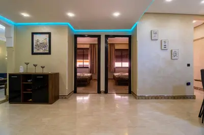 a lobby with blue lights on the walls and doors at Harmony Inn Entire 2 bedroom apartment in Marrakech