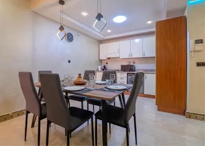 a kitchen and dining room with a table and chairs at Harmony Inn Entire 2 bedroom apartment in Marrakech