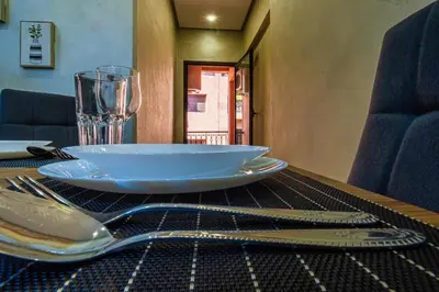 a table with a plate and a glass on it at Harmony Inn Entire 2 bedroom apartment in Marrakech