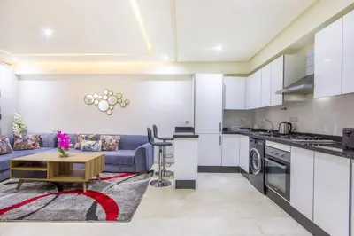 a kitchen and living room with a couch and a table at Relax, Modern, Centre Gueliz in Marrakech