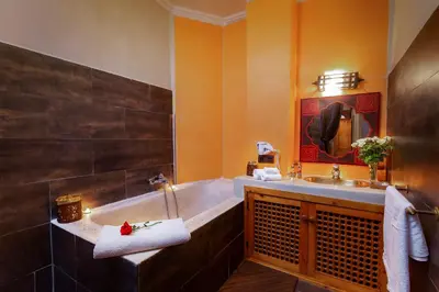 a bathroom with a tub and a sink at Riad Rodaina & SPA in Marrakech