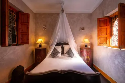 a bedroom with a bed with a mosquito net at Riad Rodaina & SPA in Marrakech