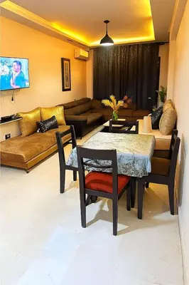 a living room with a couch and a table at Bonheur Partagé 1 in Marrakech