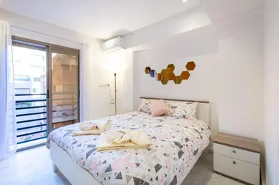 a white bedroom with a bed with towels on it at NEW! Luxury’n Colorful, Gueliz in Marrakech