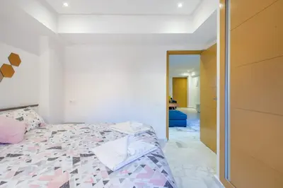 a bedroom with a bed and a door to a hallway at NEW! Luxury’n Colorful, Gueliz in Marrakech