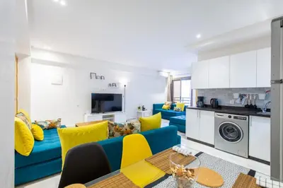 a living room with a blue couch and yellow pillows at NEW! Luxury’n Colorful, Gueliz in Marrakech
