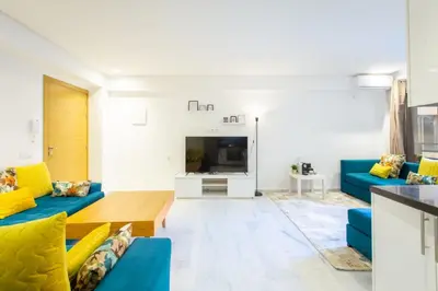 a living room with blue couches and a tv at NEW! Luxury’n Colorful, Gueliz in Marrakech