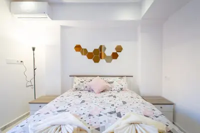 a bedroom with a bed with a comforter at NEW! Luxury’n Colorful, Gueliz in Marrakech