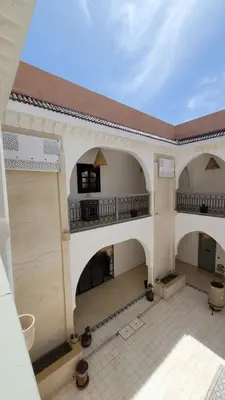 an empty building with a balcony and a patio at Riad Nohad Marrakech Villa Privatisée in Oulad Boudene