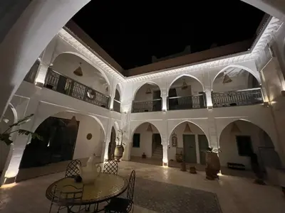 a room with a table and chairs in a building at Riad Nohad Marrakech Villa Privatisée in Oulad Boudene