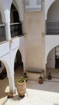 a building with a courtyard with potted plants in it at Riad Nohad Marrakech Villa Privatisée in Oulad Boudene