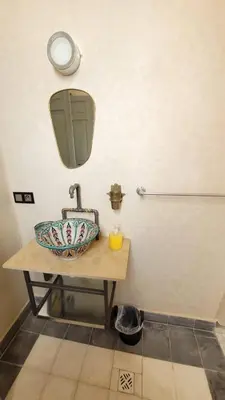 a bathroom with a sink and a mirror at Riad Nohad Marrakech Villa Privatisée in Oulad Boudene