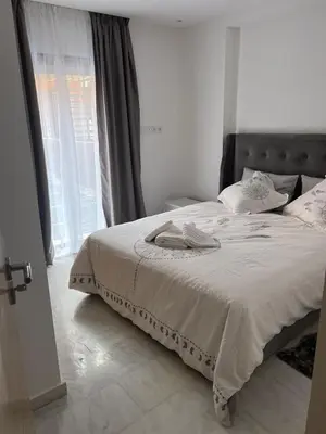 a bedroom with a bed and a large window at PALACE B Av Hassan II Marrakech 40000 -Brand New Luxury UNIT#2 & UNIT#29 in Marrakech