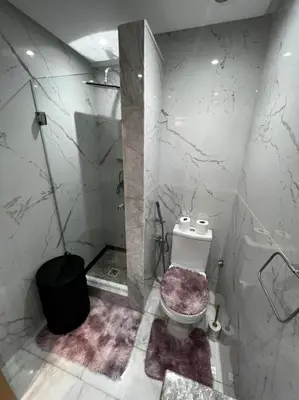 a white bathroom with a toilet and a shower at PALACE B Av Hassan II Marrakech 40000 -Brand New Luxury UNIT#2 & UNIT#29 in Marrakech